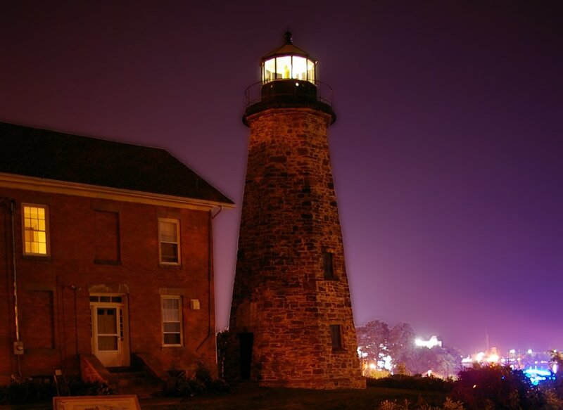 Lighthouse at night with building