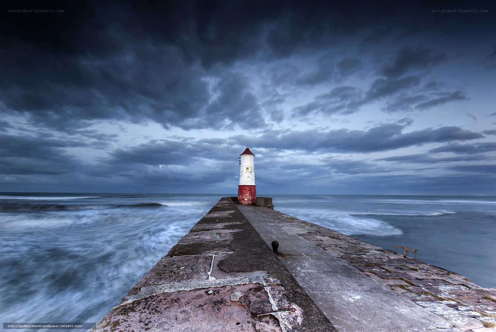 Lighthouse at stormy pier