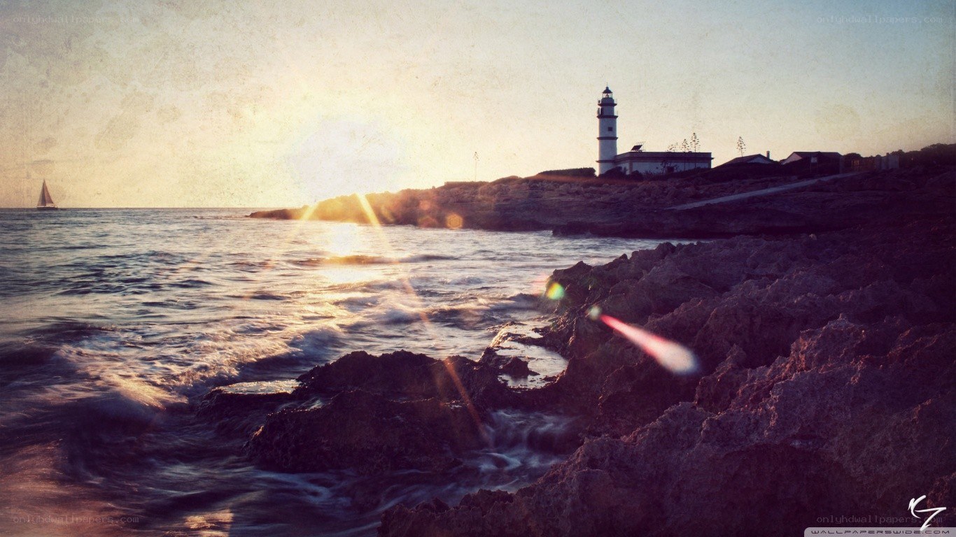lighthouse at sunset by the sea
