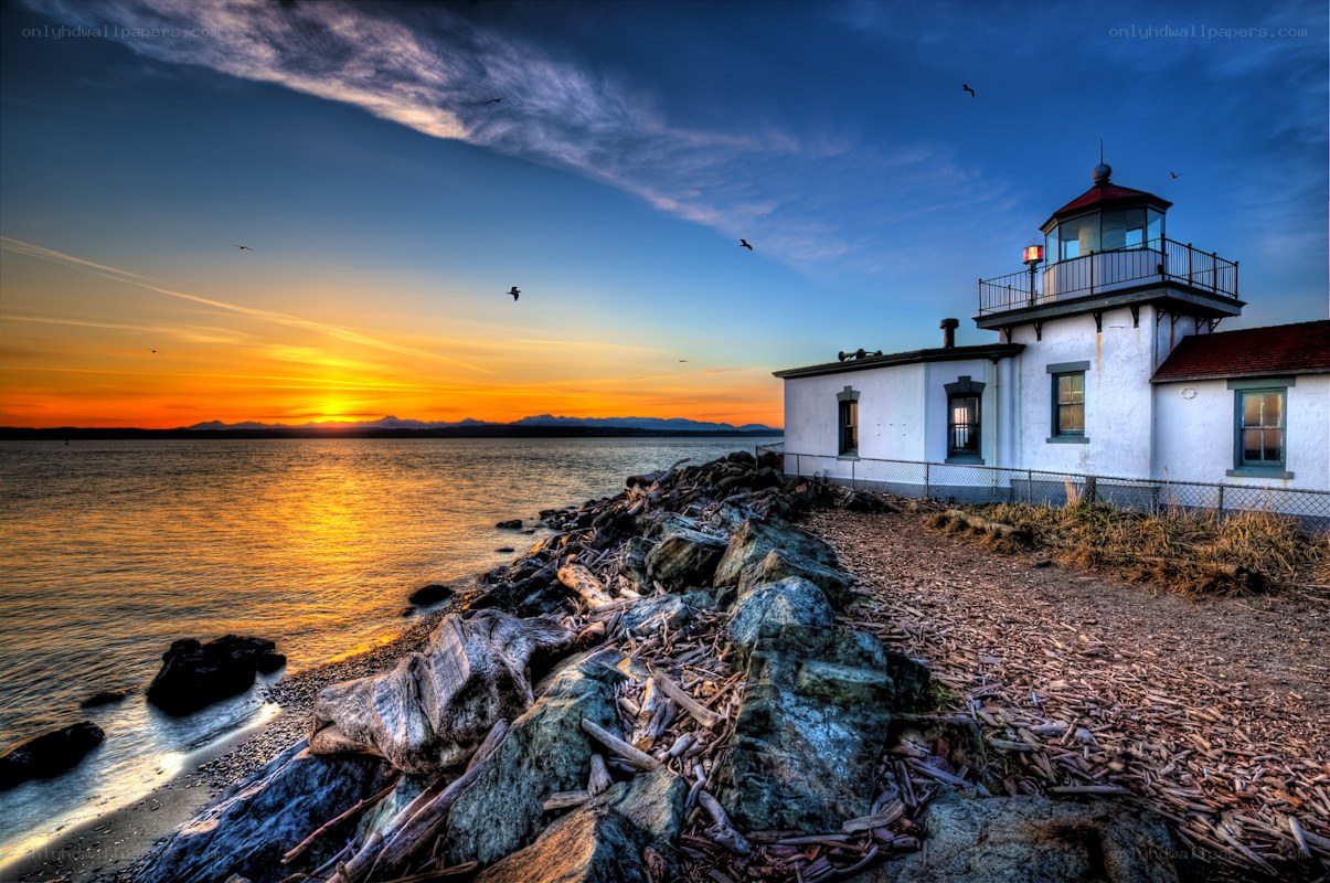 Lighthouse at sunset by the sea