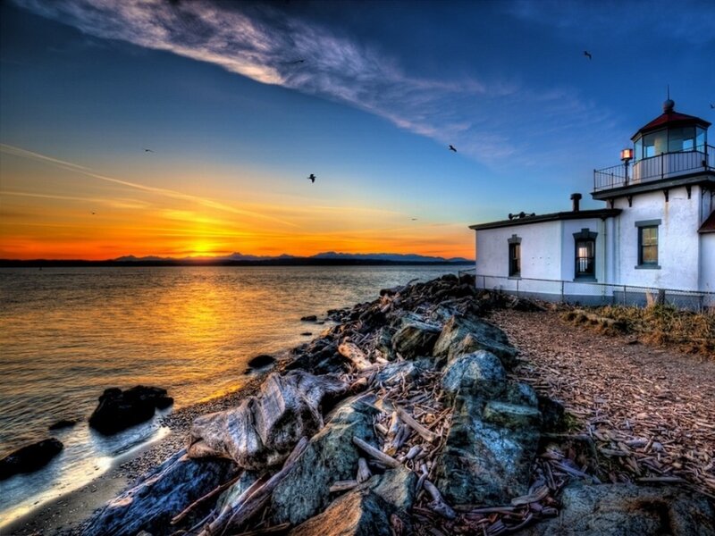 Lighthouse at sunset by the sea
