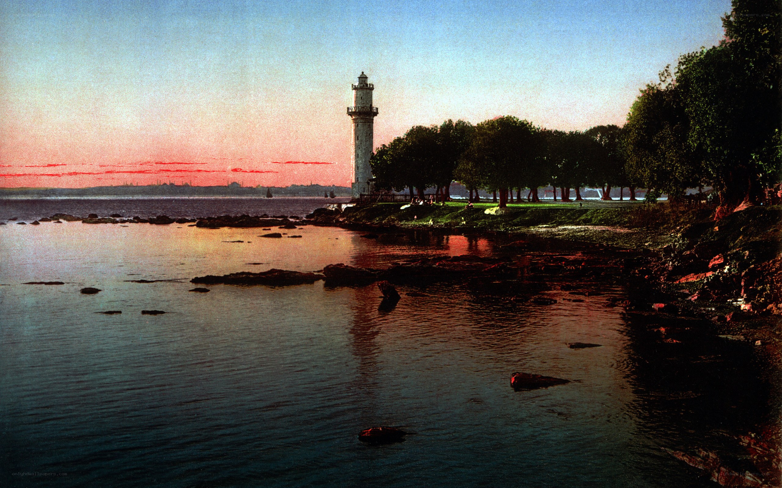 Lighthouse at sunset by the sea