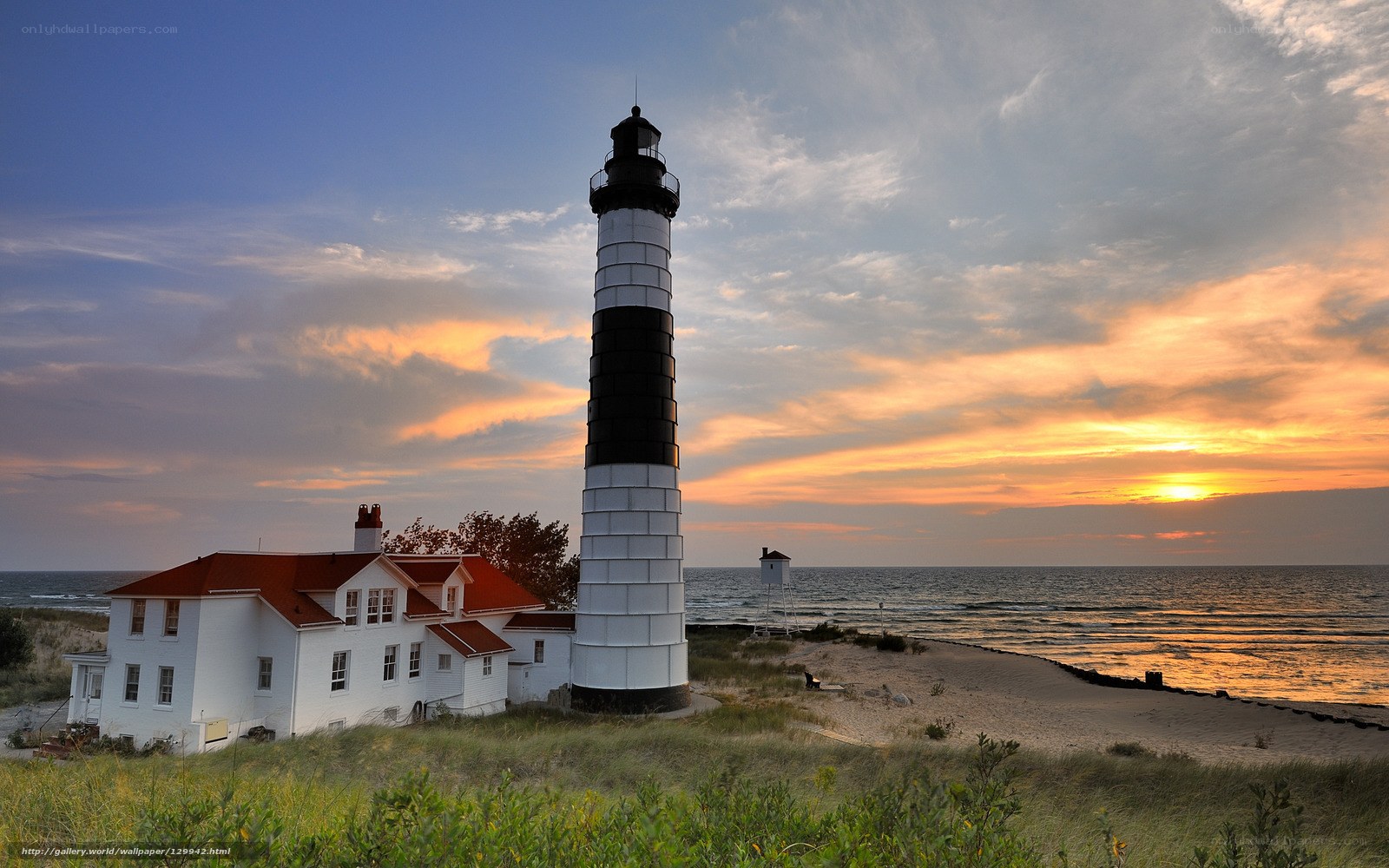 Lighthouse at sunset by the sea