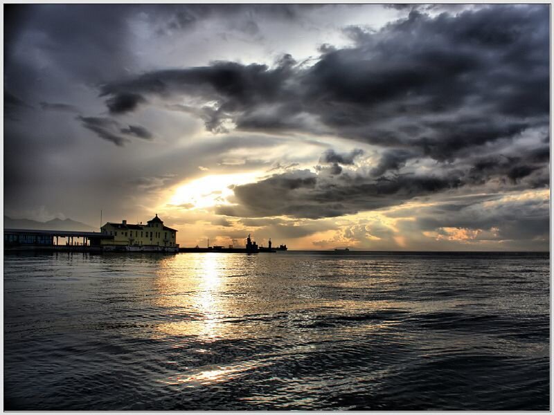 Lighthouse at Sunset — Gray, Dramatic, Photograph, Sea