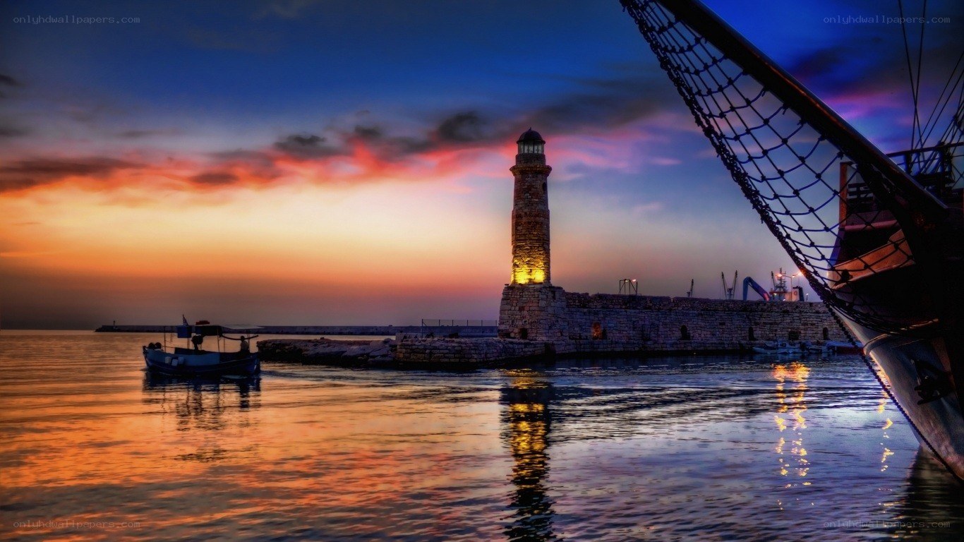 Lighthouse at sunset in a harbor