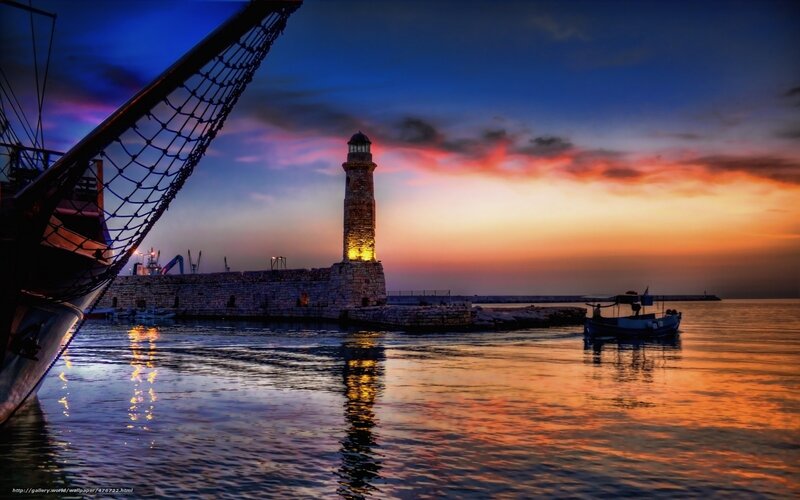 Lighthouse at sunset in harbor