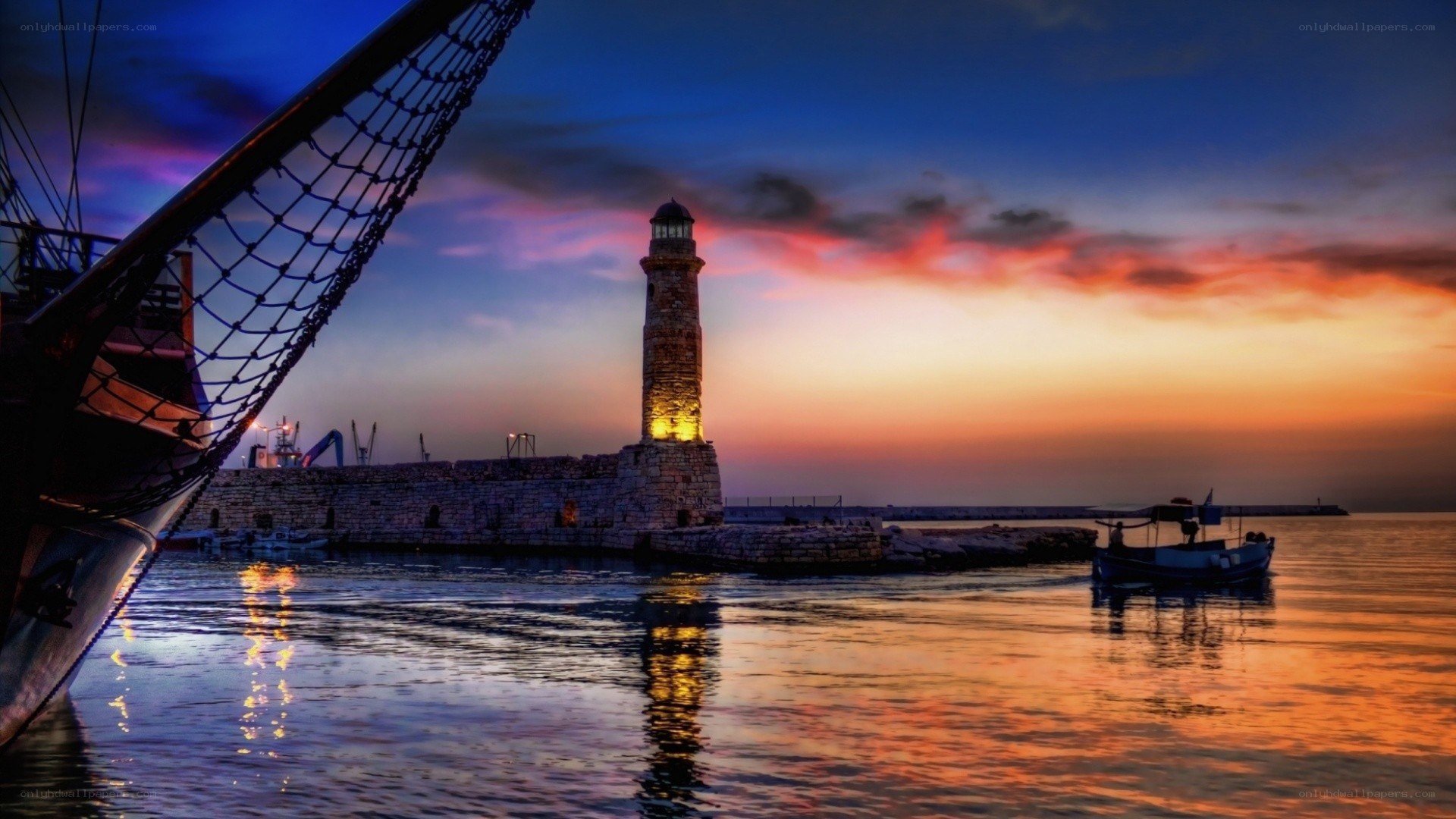 Lighthouse at sunset in harbor