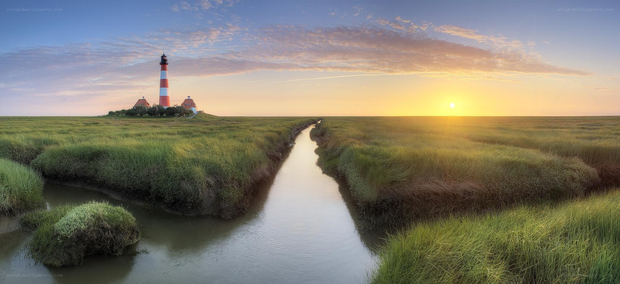 Lighthouse at sunset in marshland