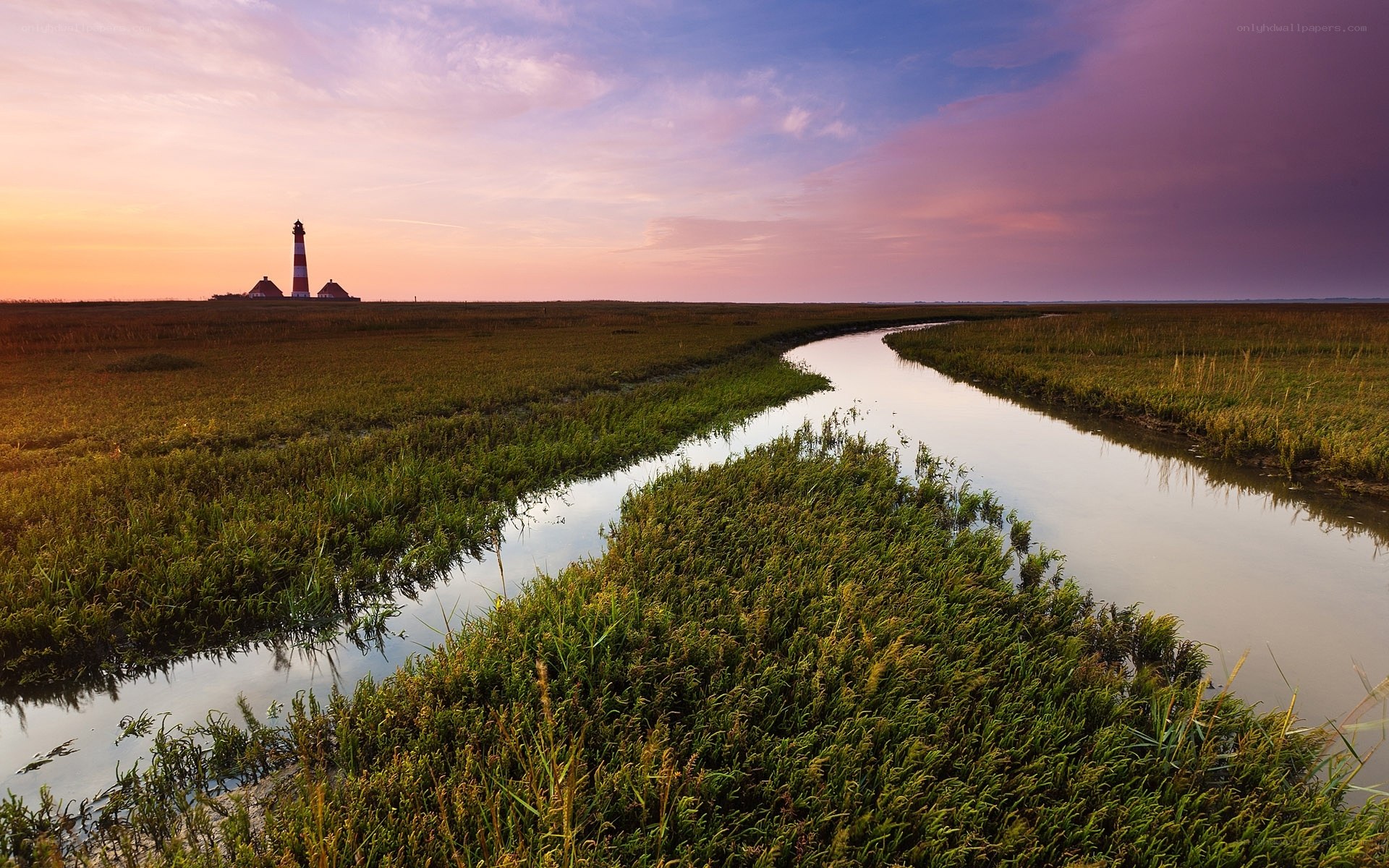 Lighthouse at sunset in marshland