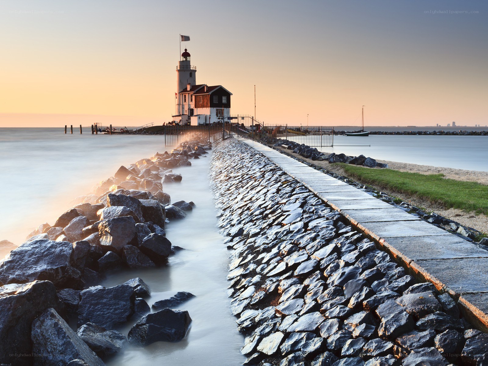 Lighthouse at sunset on a breakwater
