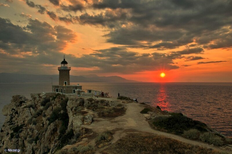 Lighthouse at sunset on a cliff