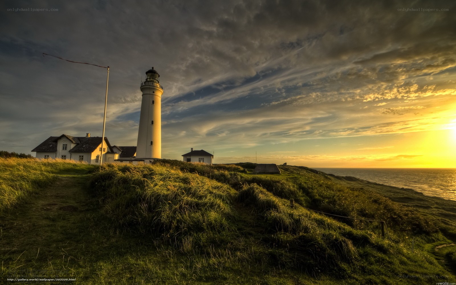 Lighthouse at sunset on a cliff