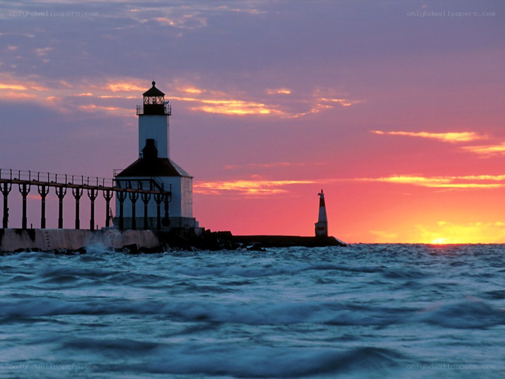 Lighthouse at sunset on a lake