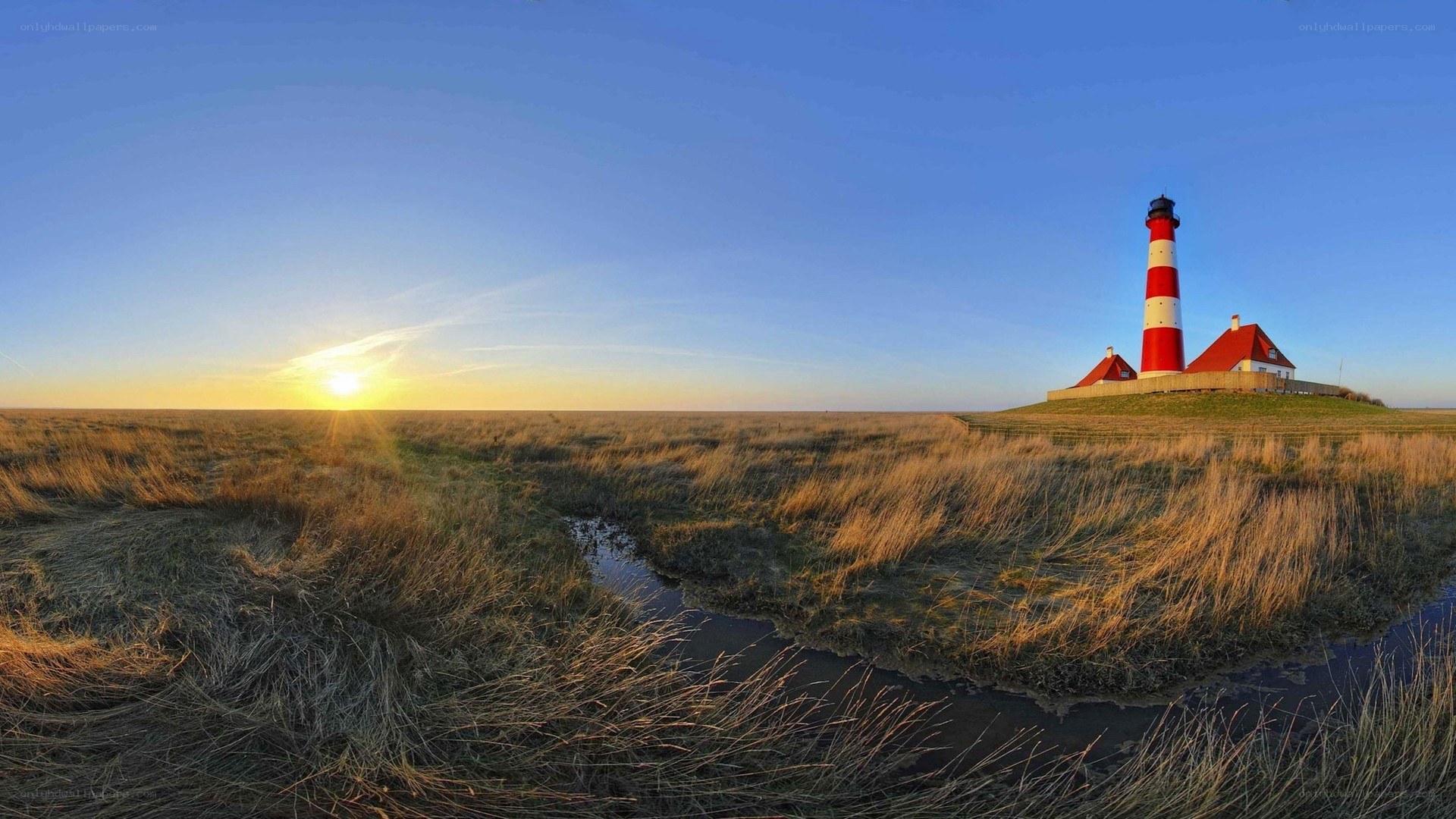 Lighthouse at sunset on a marsh