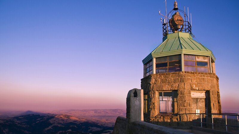 Lighthouse at sunset on a mountain