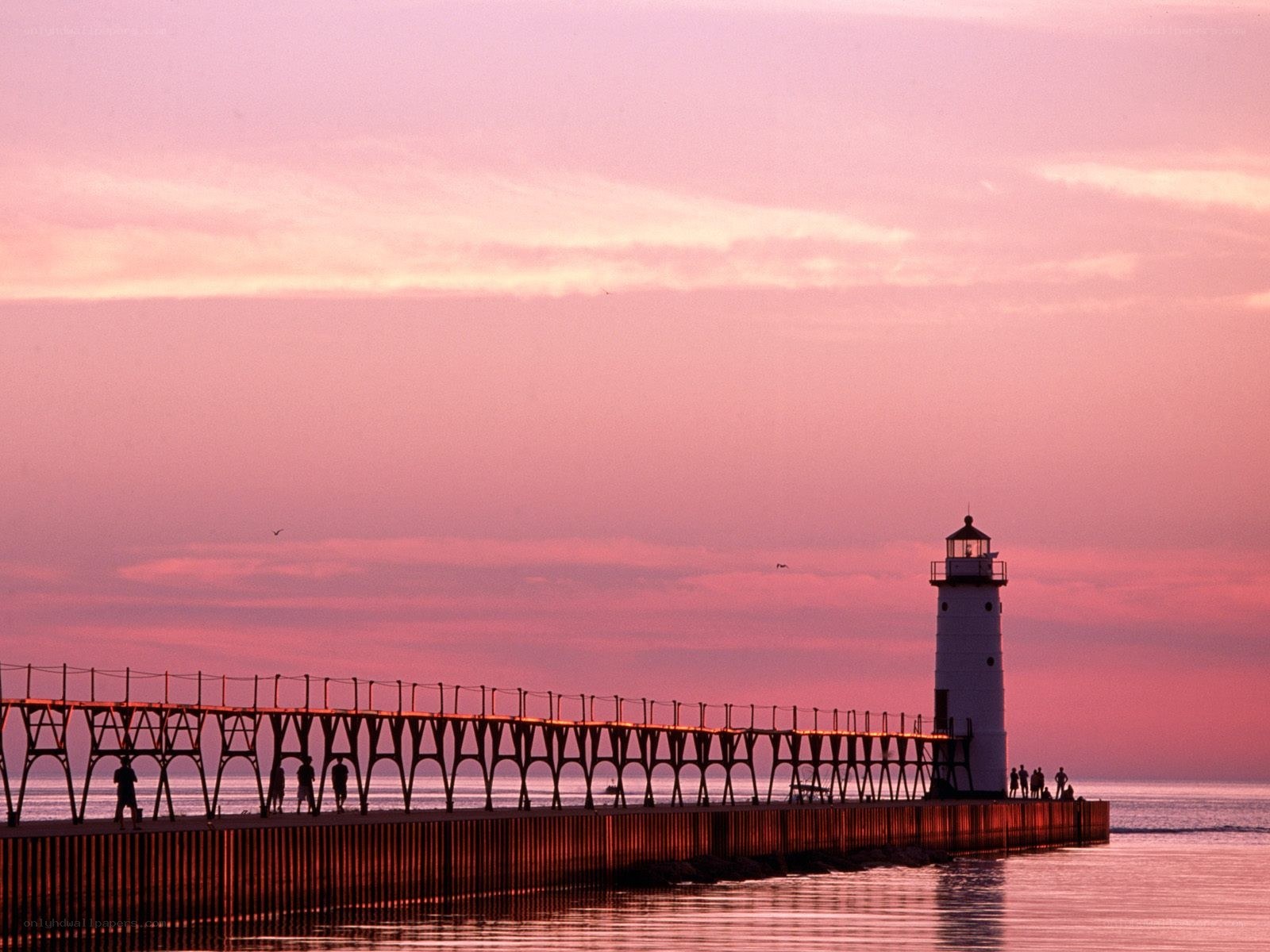 Lighthouse at sunset on a pier