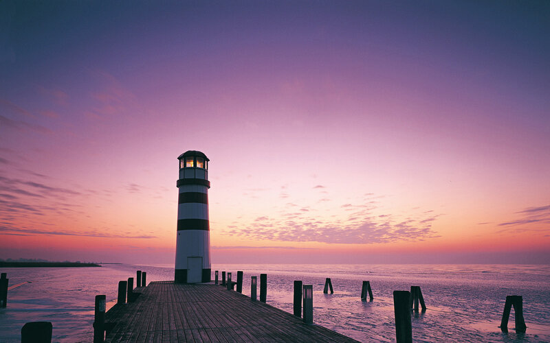 Lighthouse at sunset on a pier
