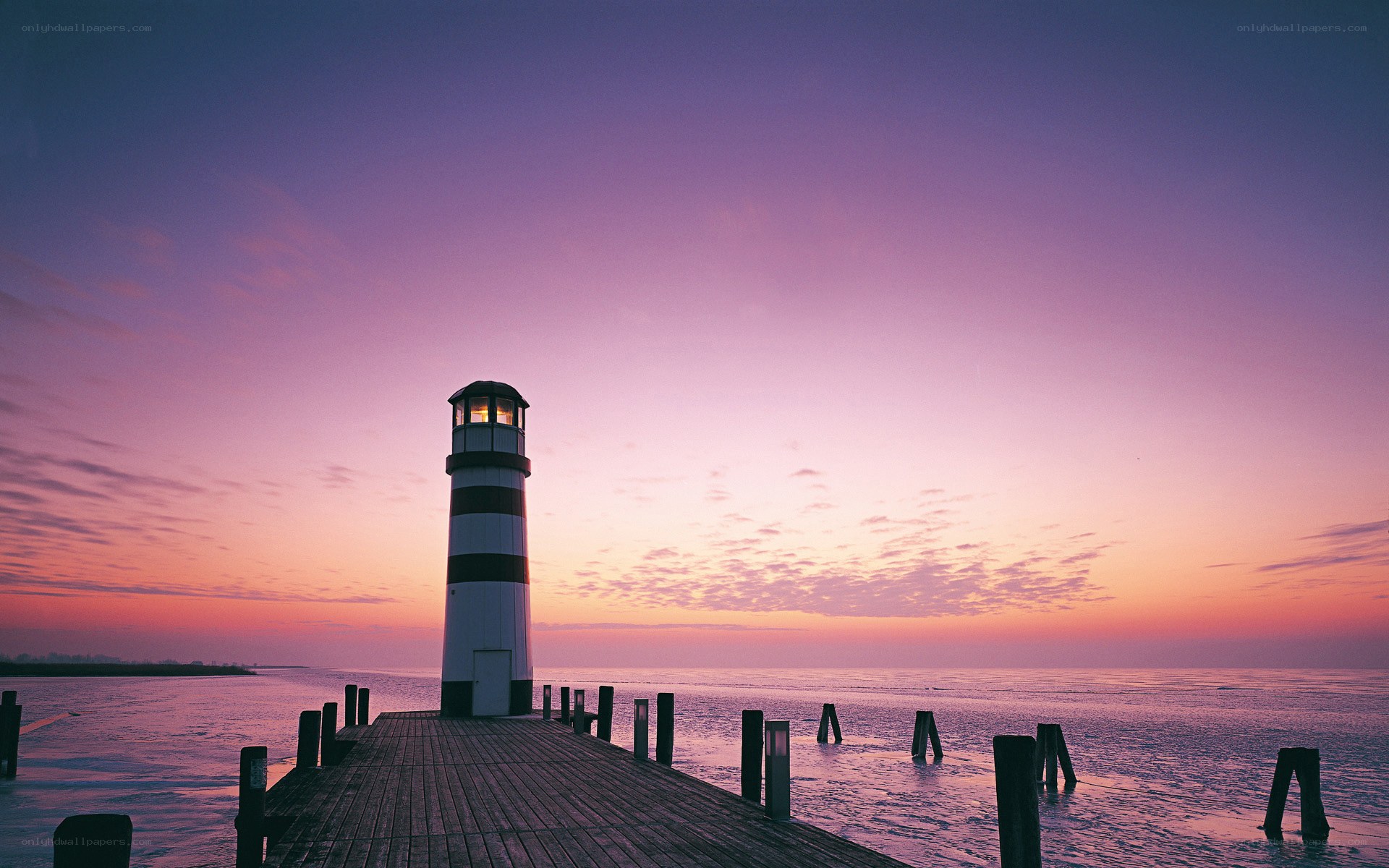 Lighthouse at sunset on a pier
