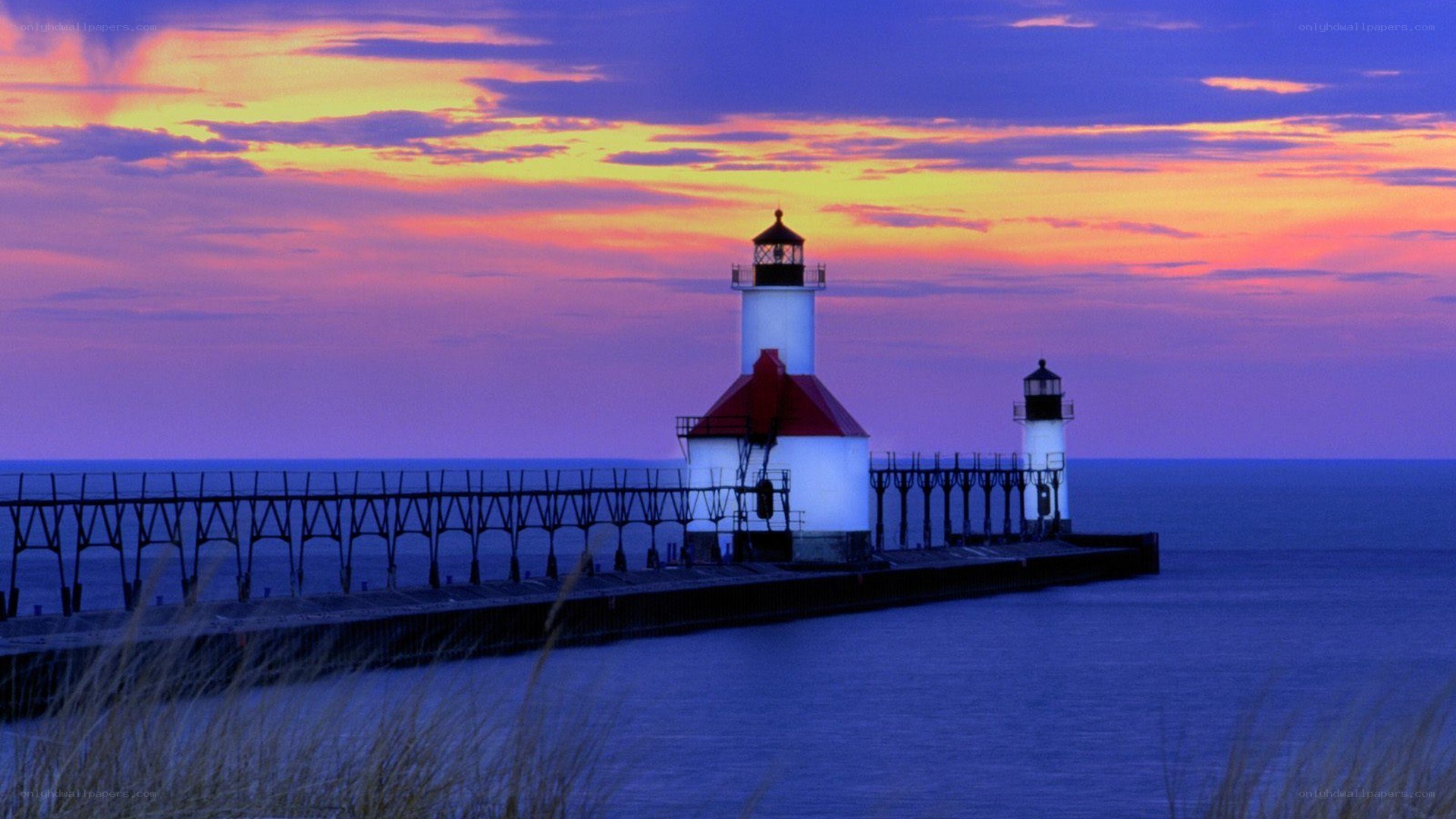 Lighthouse at sunset on a pier