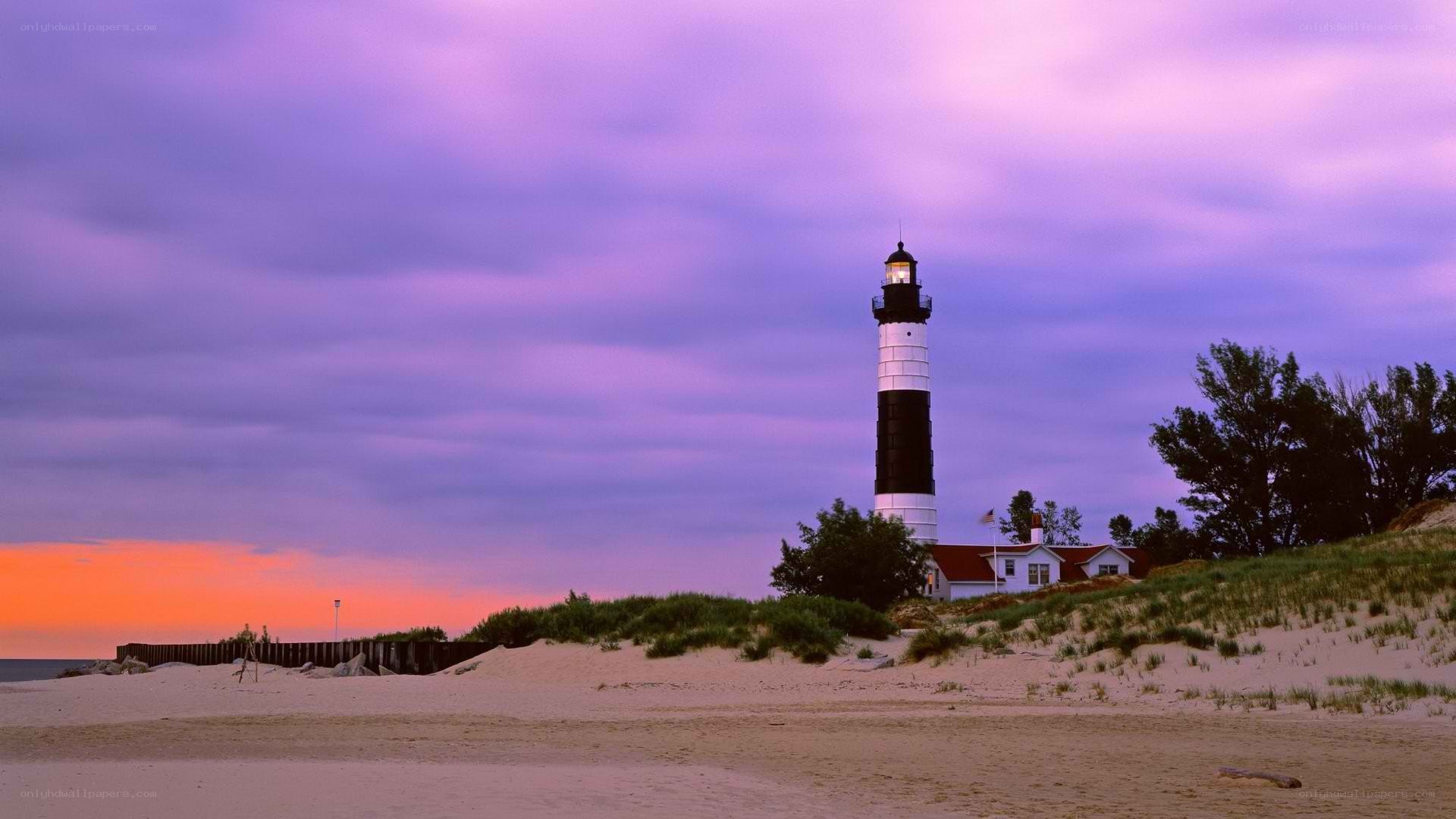 lighthouse at sunset on beach