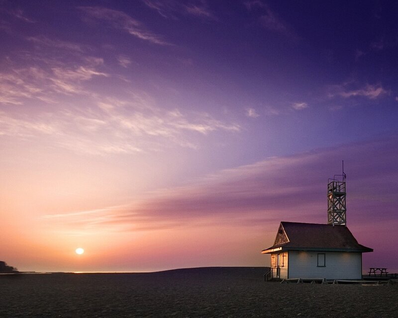 Lighthouse at sunset on beach