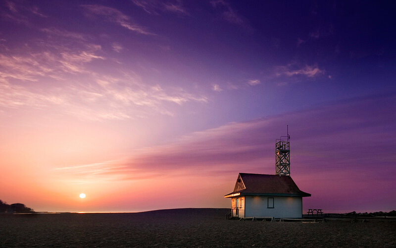 Lighthouse at sunset on beach