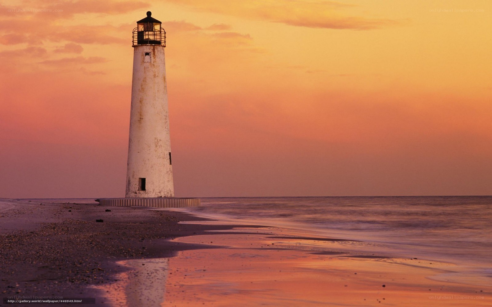 lighthouse at sunset on beach