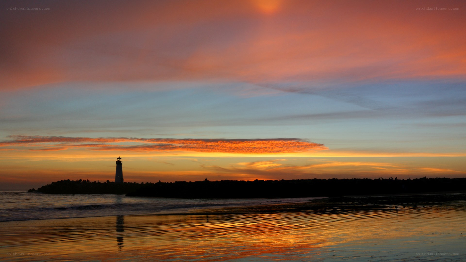 Lighthouse at sunset on beach