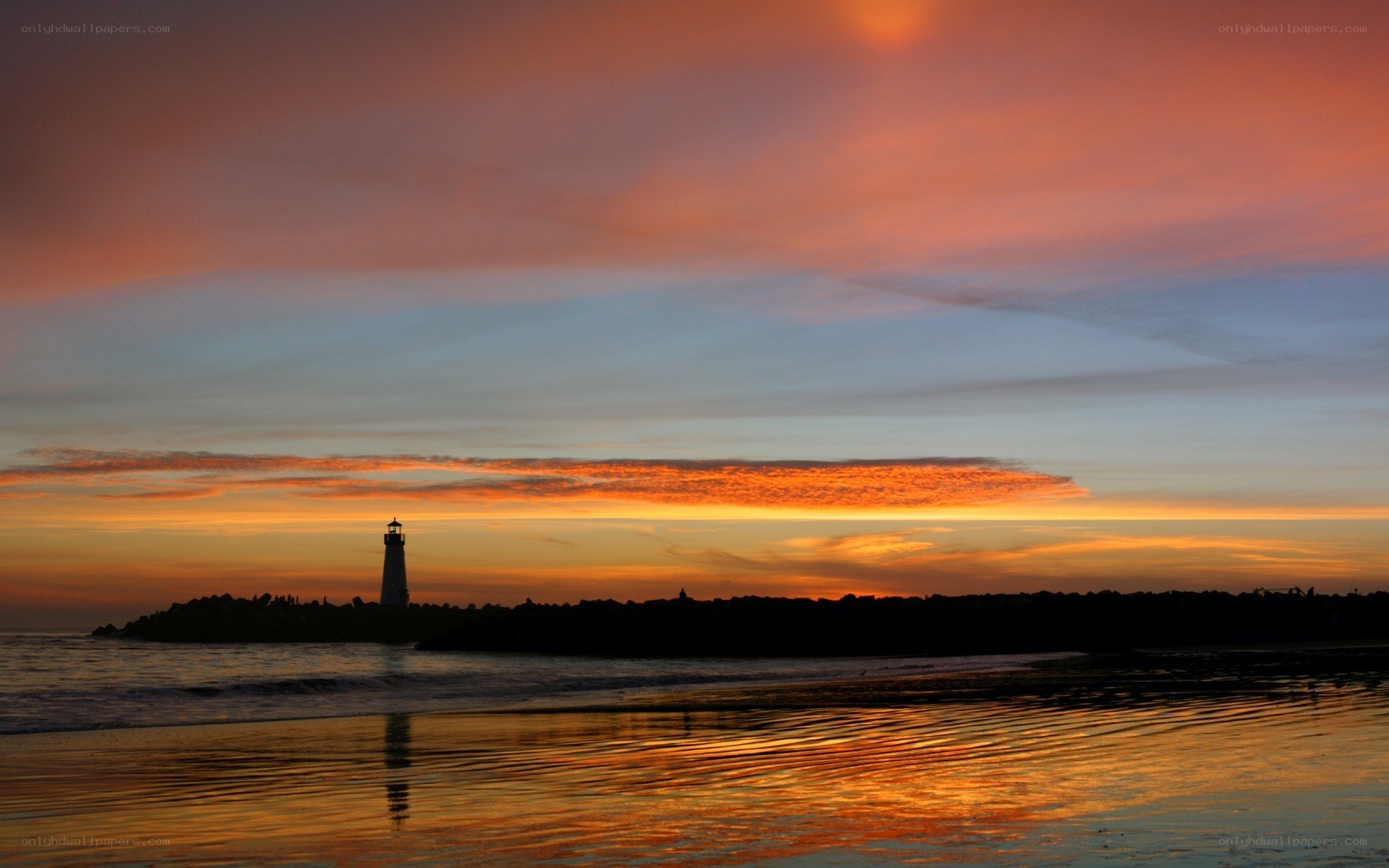 lighthouse at sunset on beach