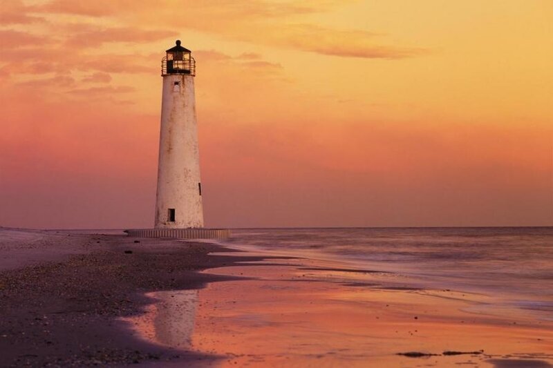 lighthouse at sunset on beach