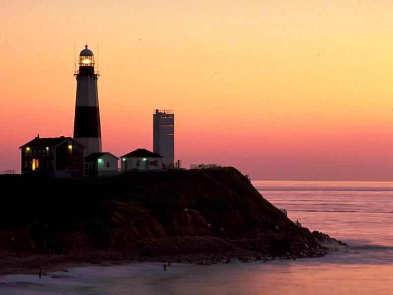 lighthouse at sunset on cliff