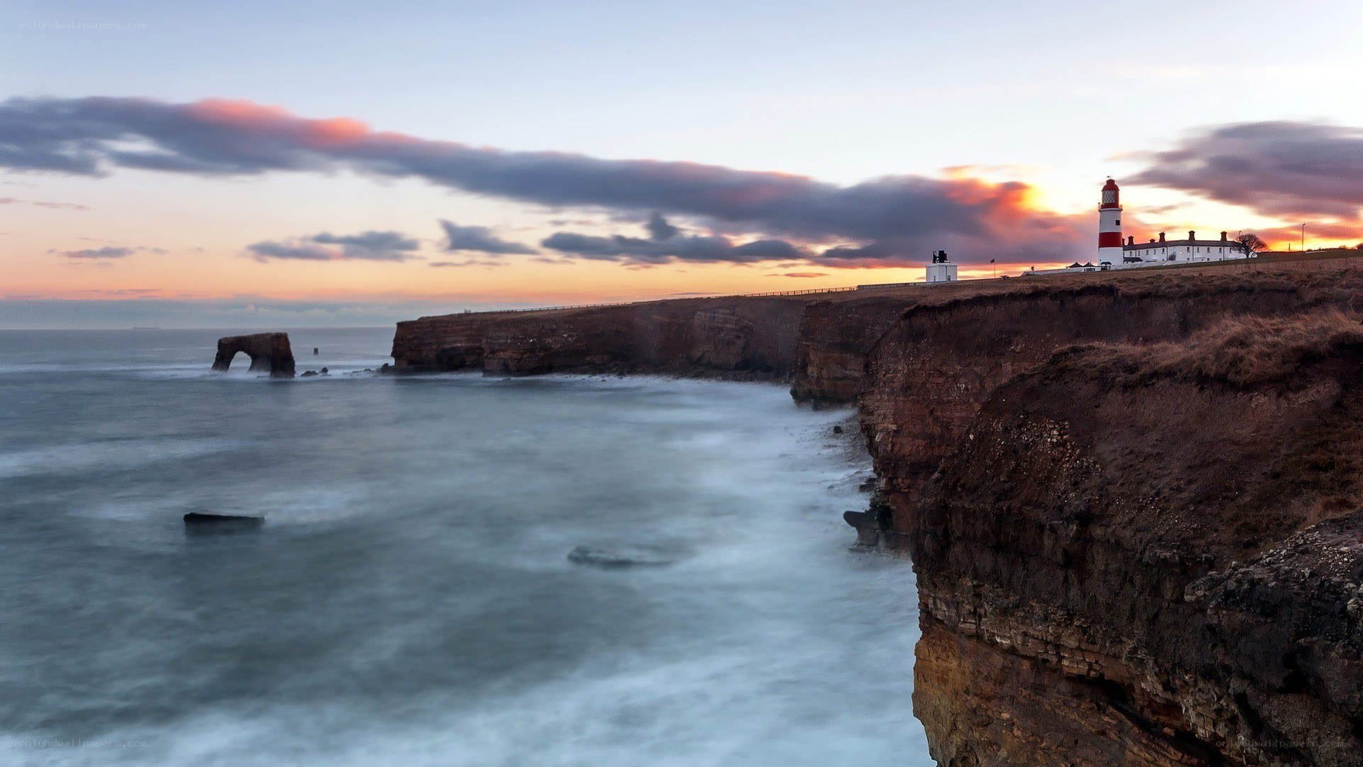 lighthouse at sunset on cliffs