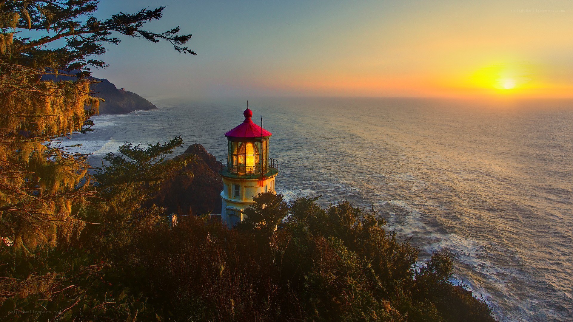 lighthouse at sunset on coast