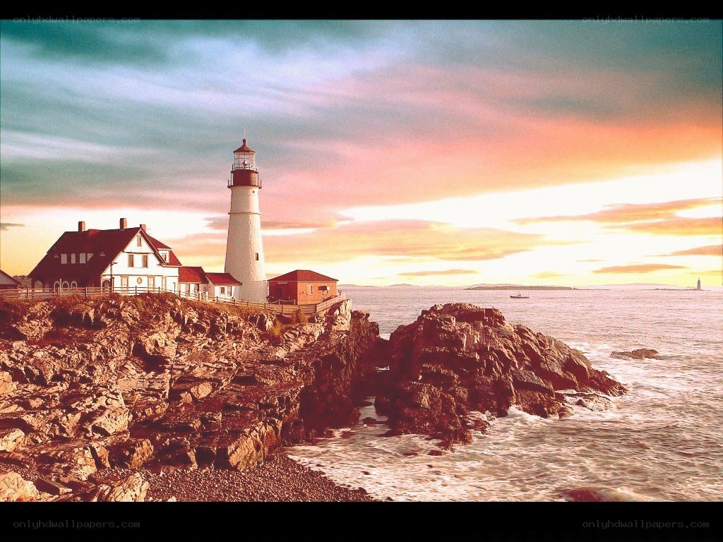 Lighthouse at sunset on rocky coast