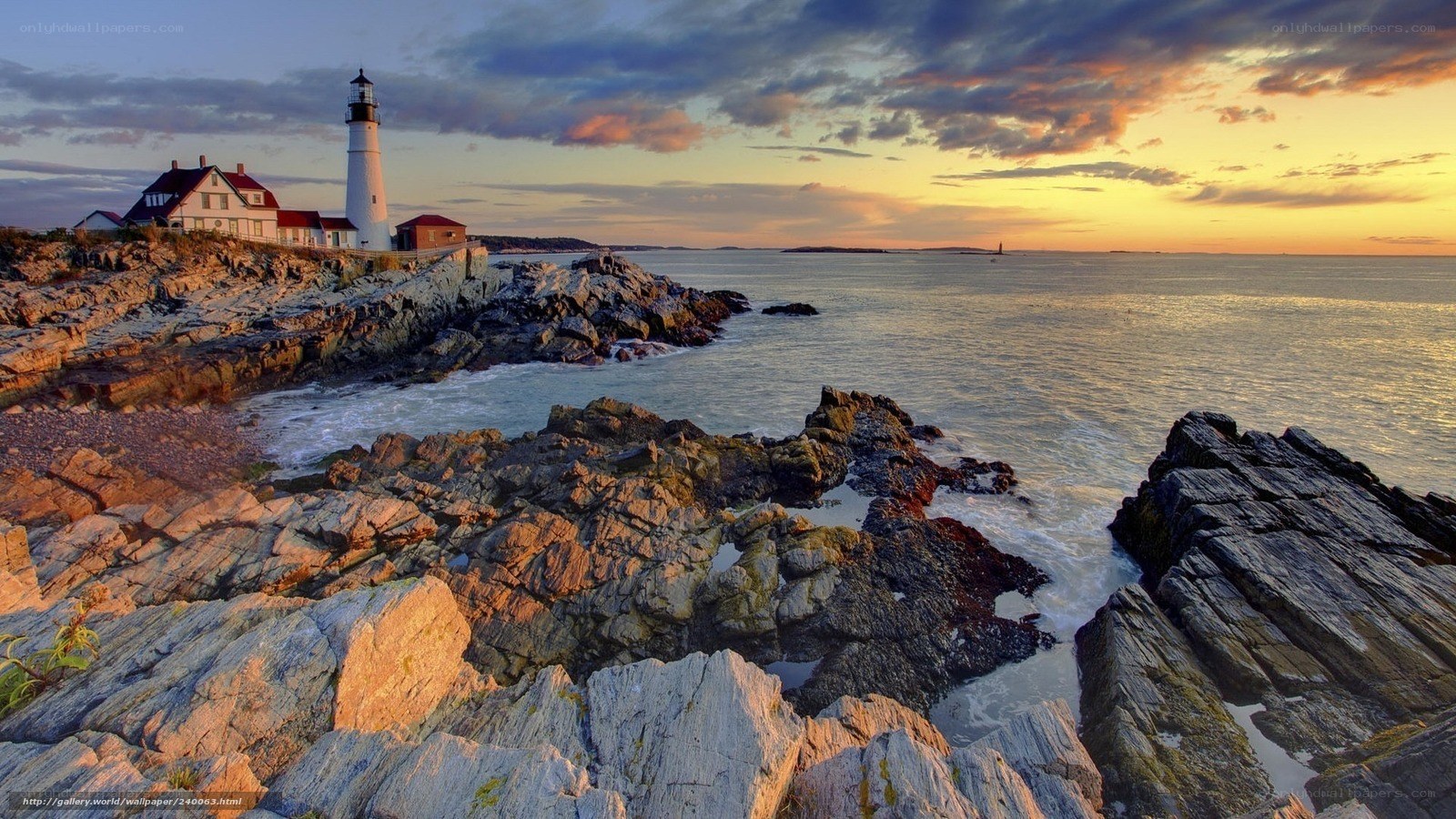 lighthouse at sunset on rocky coast
