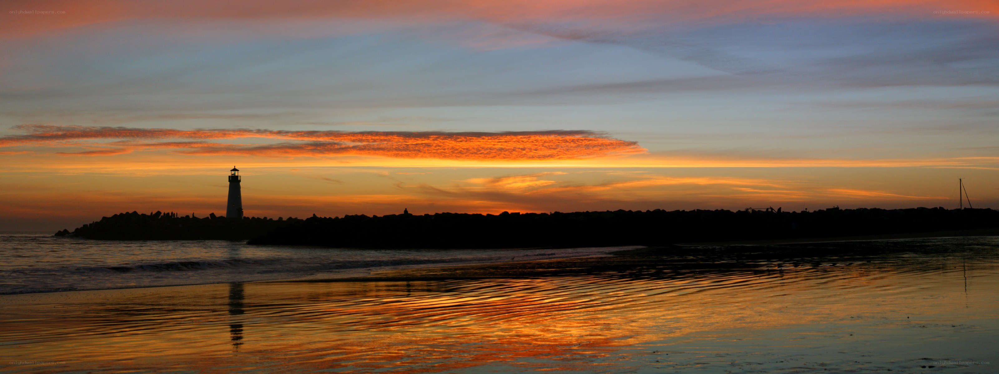 Lighthouse at sunset on the beach