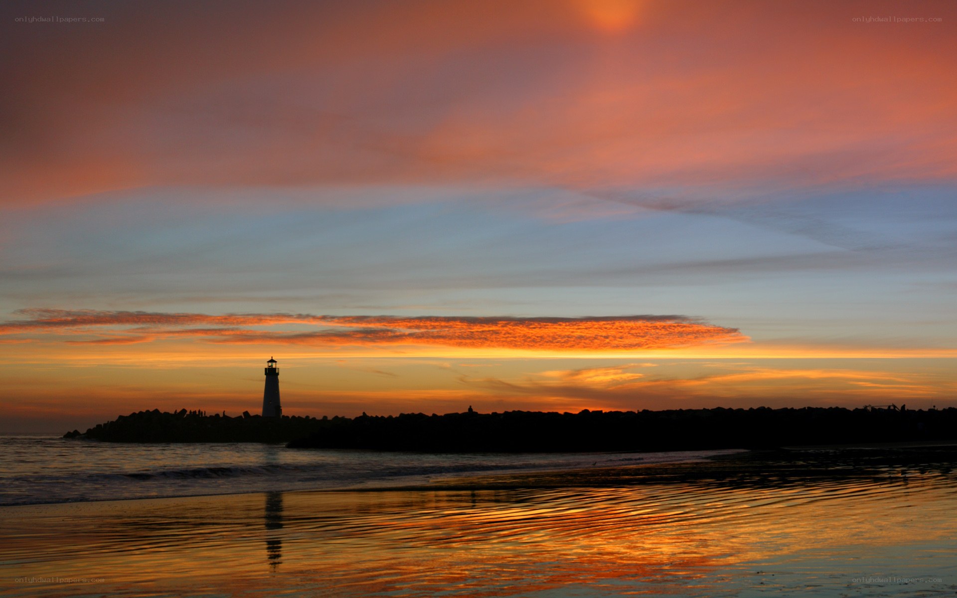 Lighthouse at sunset on the beach