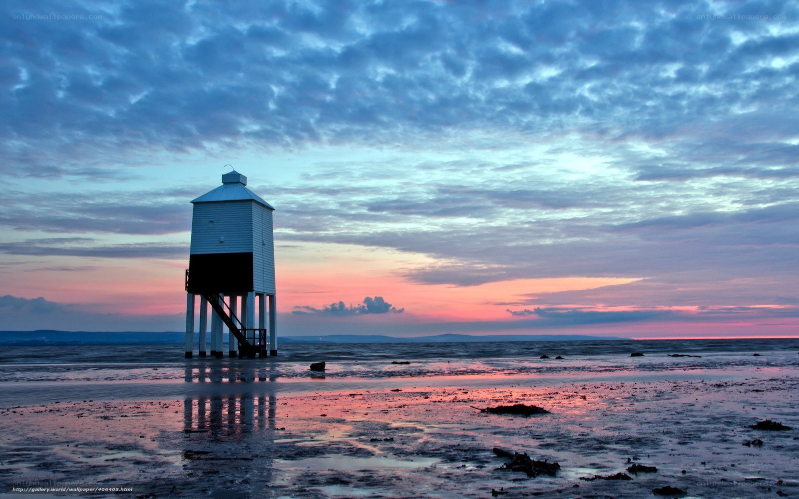 Lighthouse at sunset on the beach