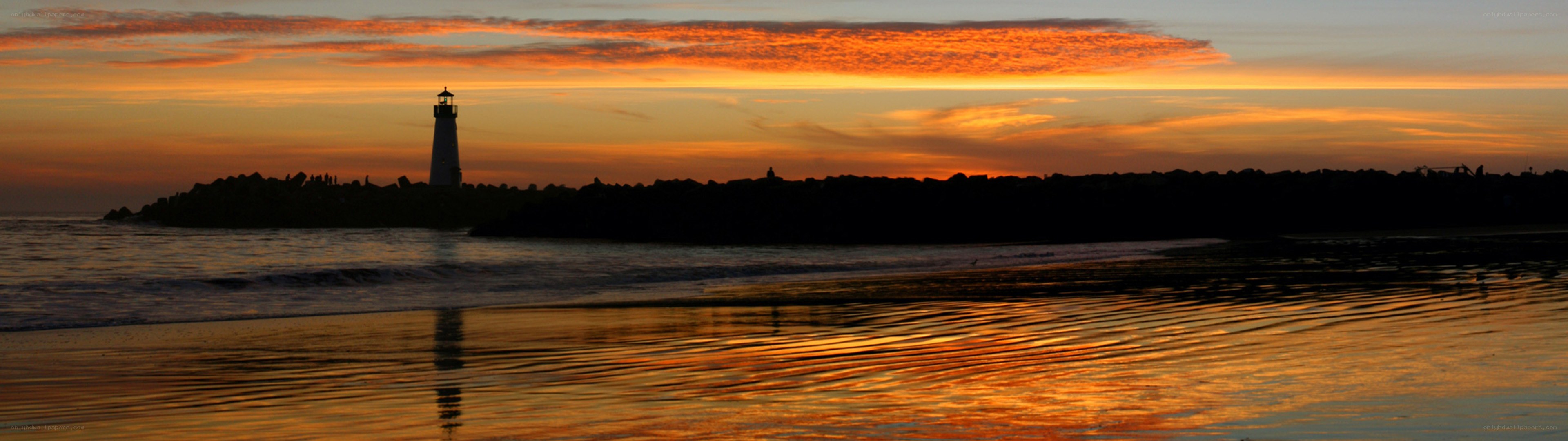 Lighthouse at sunset on the coast