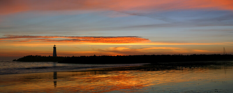 lighthouse at sunset on the coast