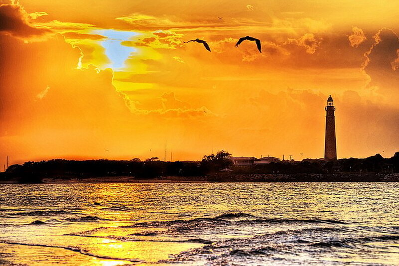 Lighthouse at Sunset — Orange, Dramatic, Photograph, Birds