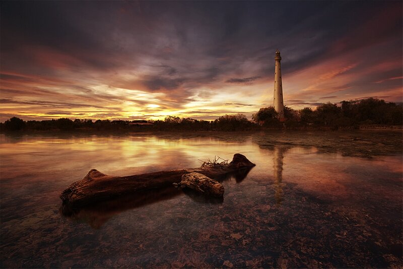 Lighthouse at Sunset — Orange, Dramatic, Photograph, Driftwood