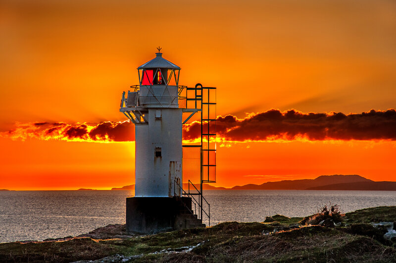 Lighthouse at Sunset — Orange, Dramatic, Photograph, Ocean, Sky, Mountains