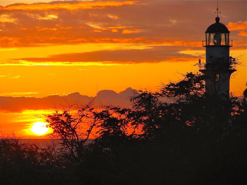 Lighthouse at Sunset — Orange, Dramatic, Photograph, Sun, Clouds, Trees