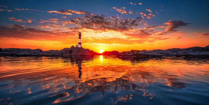 Lighthouse at Sunset — Orange, Dramatic, Photograph, Sun, Rocks, Water