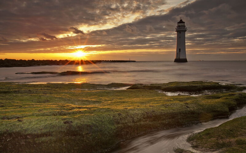 Lighthouse at Sunset — Orange, Dramatic, Photograph, Sun, Sea, Rocks