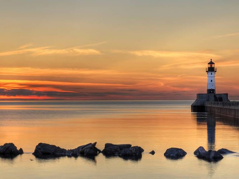 Lighthouse at Sunset — Orange, Serene, Photograph, Ocean, Rocks, Sky