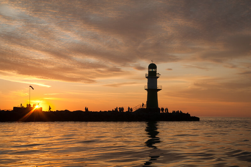 Lighthouse at Sunset — Orange, Serene, Photograph, People