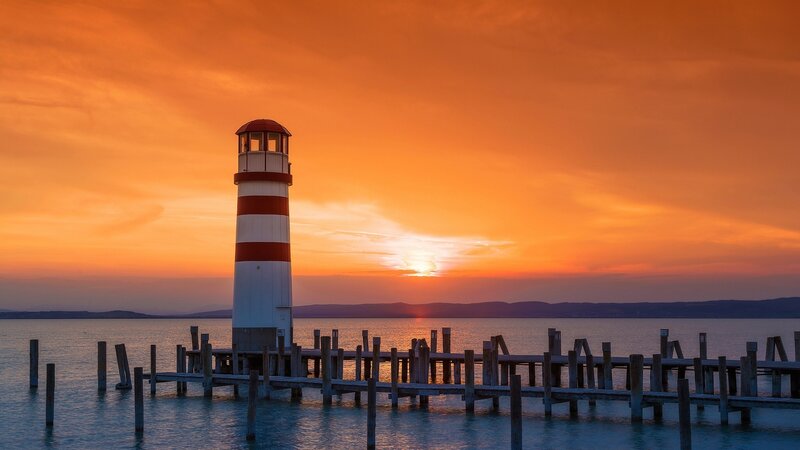 Lighthouse at Sunset — Orange, Serene, Photograph, Pier, Sun