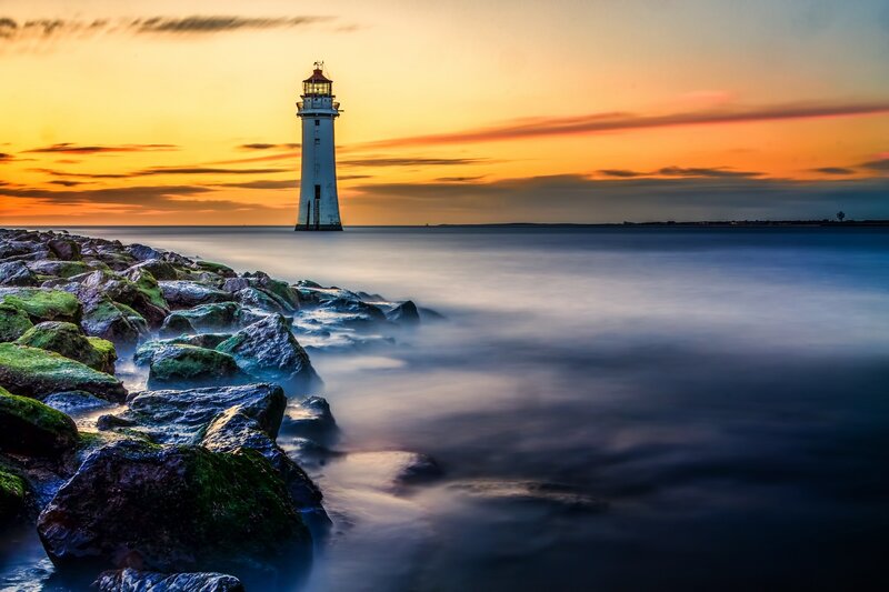 Lighthouse at Sunset — Orange, Serene, Photograph, Rocks